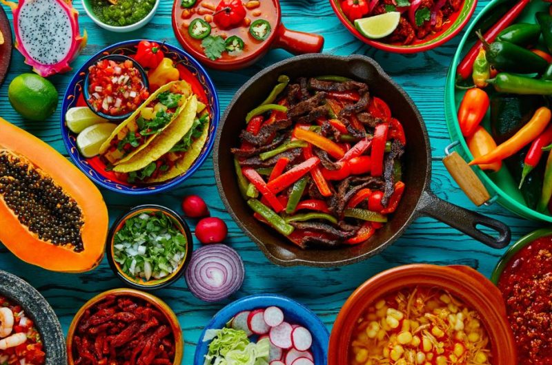 Food is culture :A variety of Mexican dishes on a wooden table.